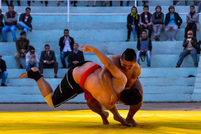 Wrestlers in action from the 30th NWA Championship. Naga wrestlers compete during the 30th NWA Naga Traditional Wrestling Championship at Kohima Local Ground in Nagaland.
