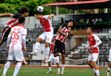 SLSA and Audax FA Impress in Arunachal Youth Premier League 2026 Arunachal Youth Premier League 2026 players contest aerial header during youth football match at Golden Jubilee Outdoor Stadium Yupia